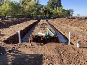 Constructing a septic system leach drainage field in a dirt yard