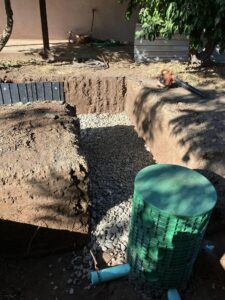 Septic system distribution box in excavated graded and gravel trench