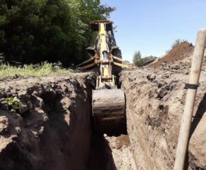 Excavating a utility trench with a backhoe tractor