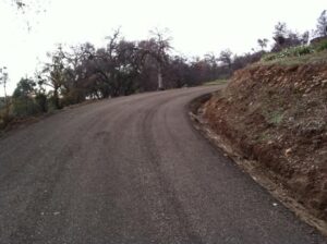 Graded and leveled gravel road winding uphill through trees in chico, ca