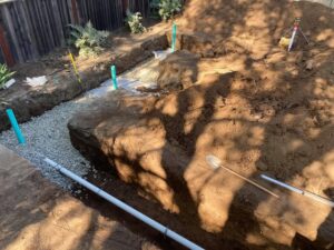 Trench in backyard with septic system lines installation