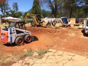 Construction site work on chico, ca property with mini bobcat, mini excavator and backhoe